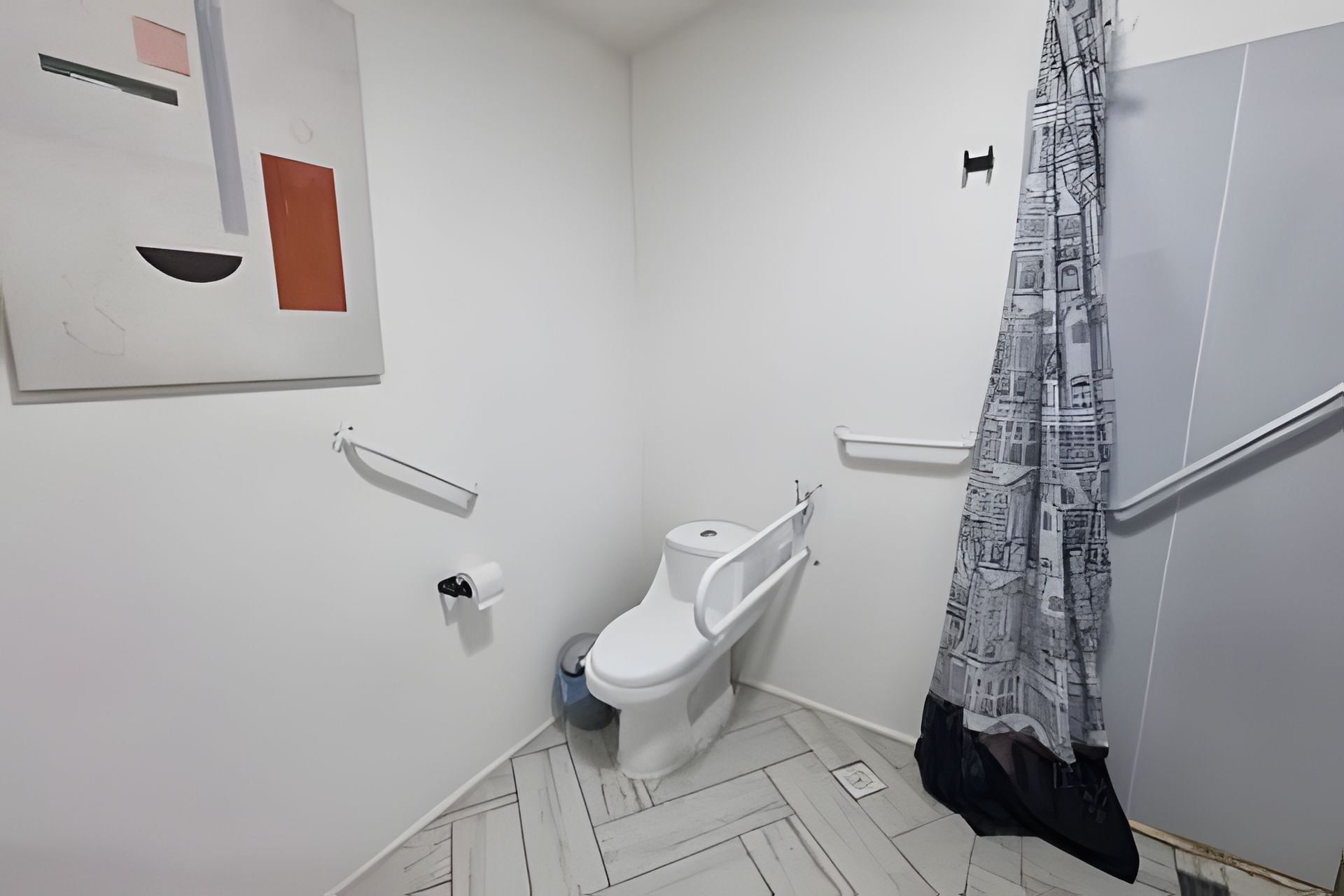 A bathroom with a toilet, a handrail, and a shower curtain.
