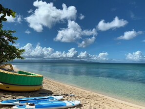 A beach with clear water, a tree, and surfboards. - Just 650 meters from the ocean! 4-bedroom villa with a large pool and bar area (Saint-François)