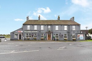 A two-story building with the sign 'Old Red House' indicating it is a pub.
