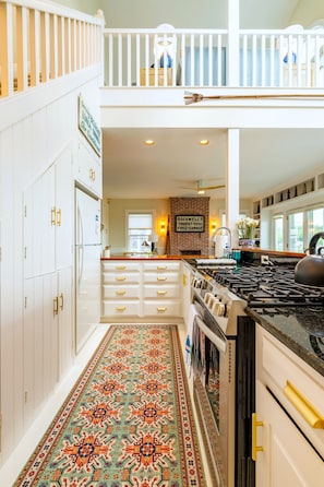 A spacious kitchen with a high ceiling, a dining area, and a view of the outdoors. - Sea Spray
Charming Three Bedroom House with amazing views of Camden Harbor (Camden)