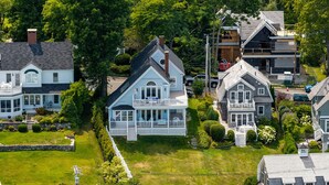 A residential area with multiple houses, including a large house with a porch and a smaller house with a garage. - Sea Spray
Charming Three Bedroom House with amazing views of Camden Harbor (Camden)