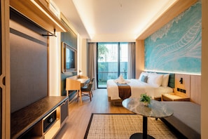 A hotel room with a bed, a desk, a chair, a TV, a balcony, and a large artwork on the wall.