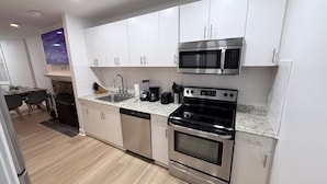 A modern kitchen with stainless steel appliances, a dishwasher, and a microwave. - 1BR in Logan Circle - DC Metro - We Host (Washington)