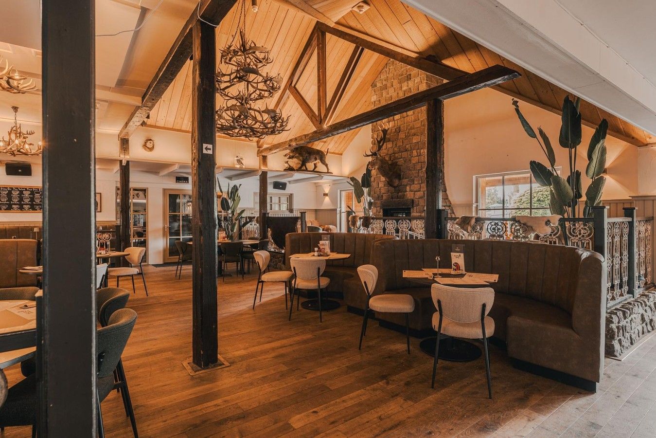 A restaurant interior with wooden floors, high ceilings, and a rustic ambiance.