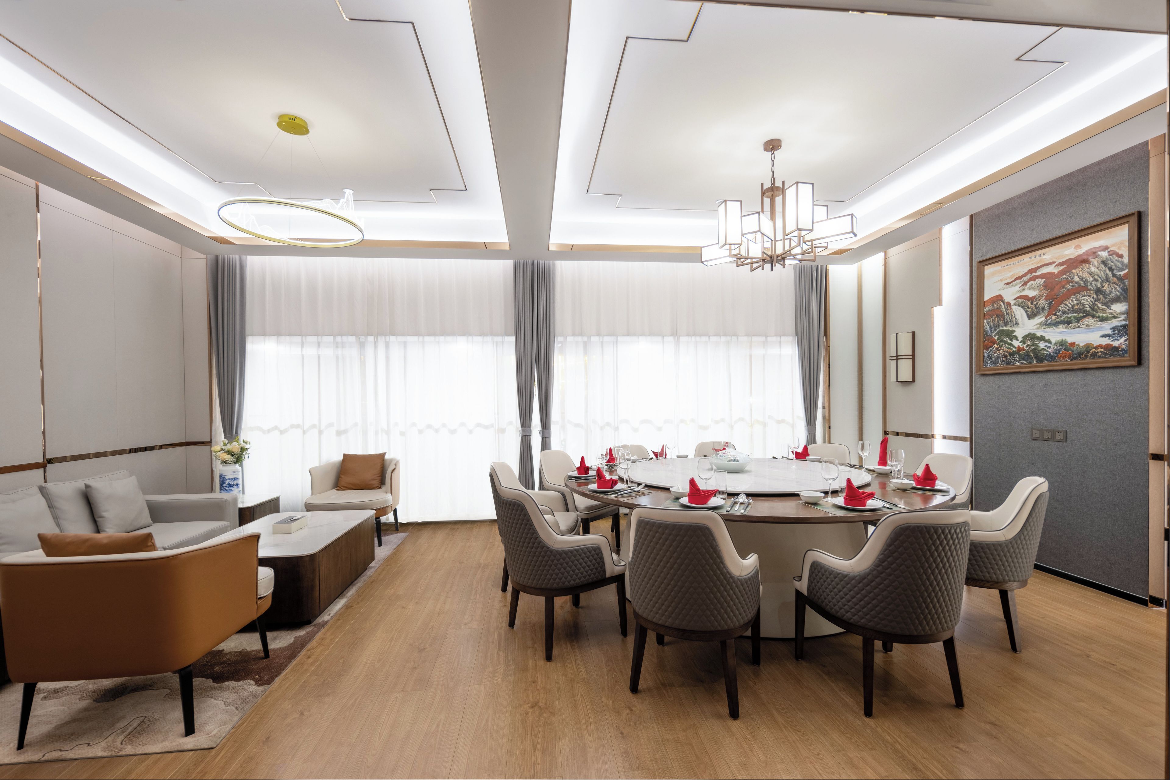 A modern dining area with a round table set for six, surrounded by six chairs.
