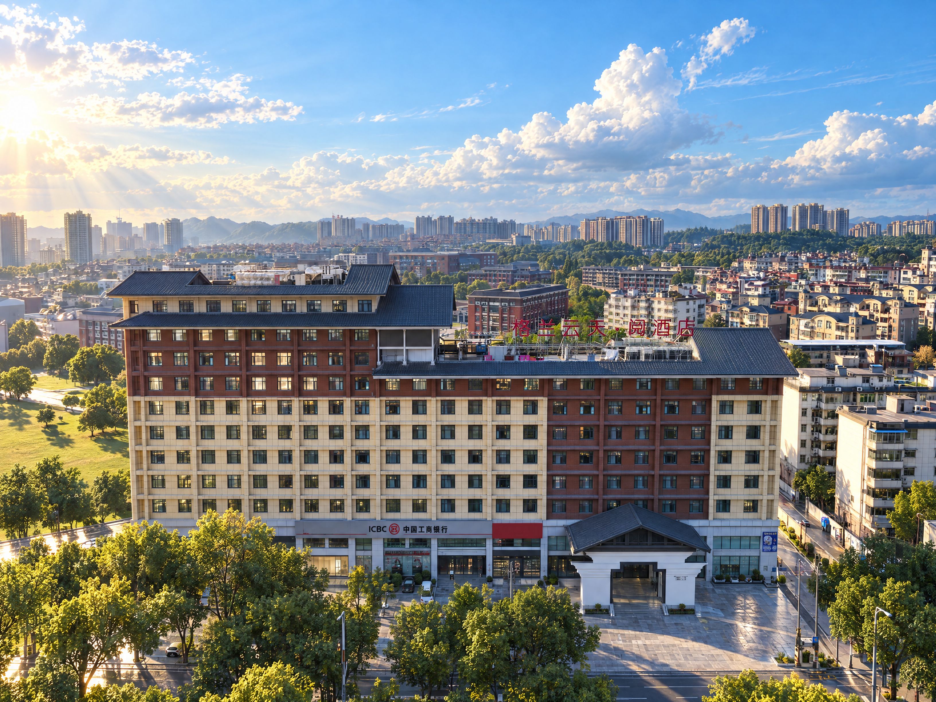 A multi-story hotel with a central courtyard, surrounded by a cityscape with various buildings and greenery.