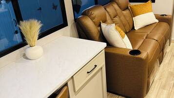 A compact living space with a sofa, a small table, and a chair.
