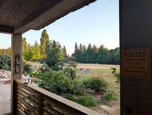 An outdoor seating area with wooden benches and a sign warning about tree monsters.