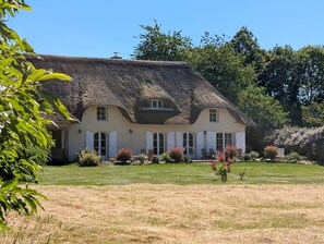 A large house with a thatched roof, multiple windows, and a well-maintained garden. - Ravissant Cottage 7 Chambres au cœur de la Bretagne Romantique - 300 m² (Epiniac)