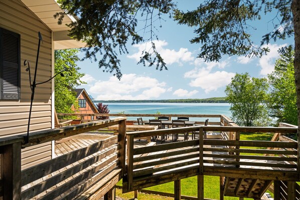 A wooden deck with outdoor furniture overlooking a lake. - Elk Lake Waterfront with Dock & Fire Pit (Williamsburg)