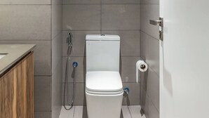 A modern bathroom with a toilet, shower, and a sign above the toilet. - Sahab - Sunset 1BR at Al mamsha Sharjah (Sharjah)