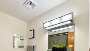 A modern bathroom with a toilet, sink, vanity, and a mirror. - Desert Oasis w/ Private Pool Near ASU (Tempe)