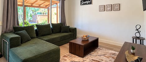 A living room with a sectional sofa, a coffee table, and a rug.