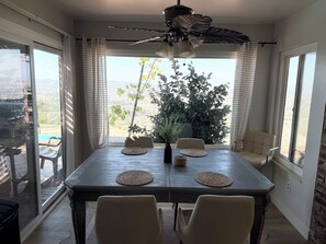 A dining area with a table, chairs, and a ceiling fan. - Spacious 5-bedroom house and Casita with endless views of the Temecula Valley (Temecula)