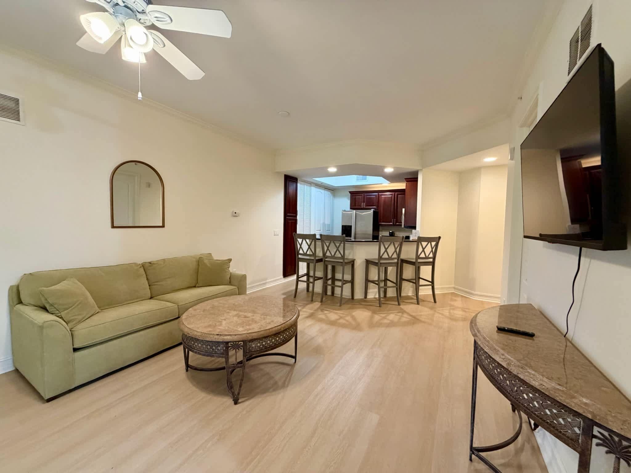 A living room with a sofa, a coffee table, and a TV stand.
