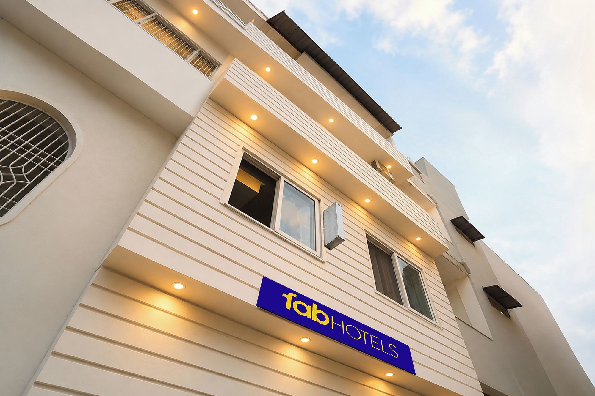 A hotel facade with a sign reading 'Tab Hotels' and multiple windows.