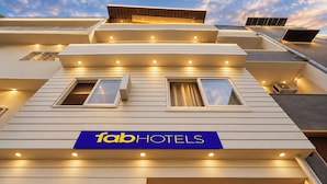 A hotel facade with a sign reading 'fabHOTELS' and multiple windows. - Fabhotel Golden Majestic (Prayagraj)