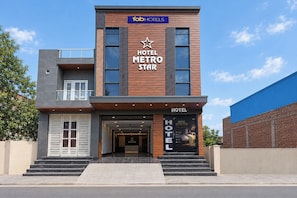 A modern hotel with a prominent sign reading 'HOTEL METRO STAR' and a star logo. - FabHotel Metro Star (New Delhi)