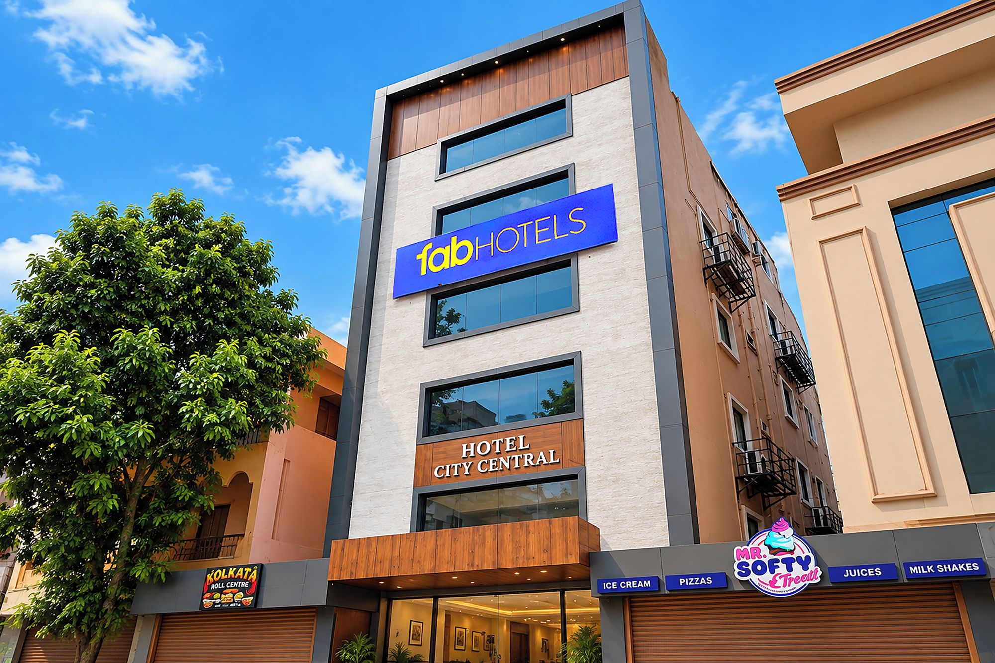 A modern hotel building with a sign for 'Tab Hotels' and 'Hotel City Central' on the facade.