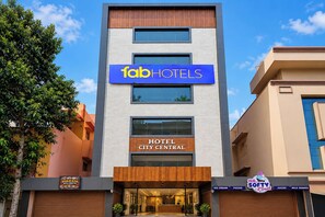 A modern hotel building with a sign for 'Tab Hotels' and 'City Central'. - FabHotel Prime City Central (Visakhapatnam)