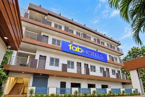 A multi-story hotel with a prominent 'fab hotels' sign, balconies, and a staircase leading to the entrance. - FabHotel Rajdhani Heritage (Ranchi)
