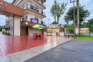 A hotel with a signboard, outdoor seating, and a restaurant named 'The Park Foods'. - FabHotel Rajdhani Heritage (Ranchi)