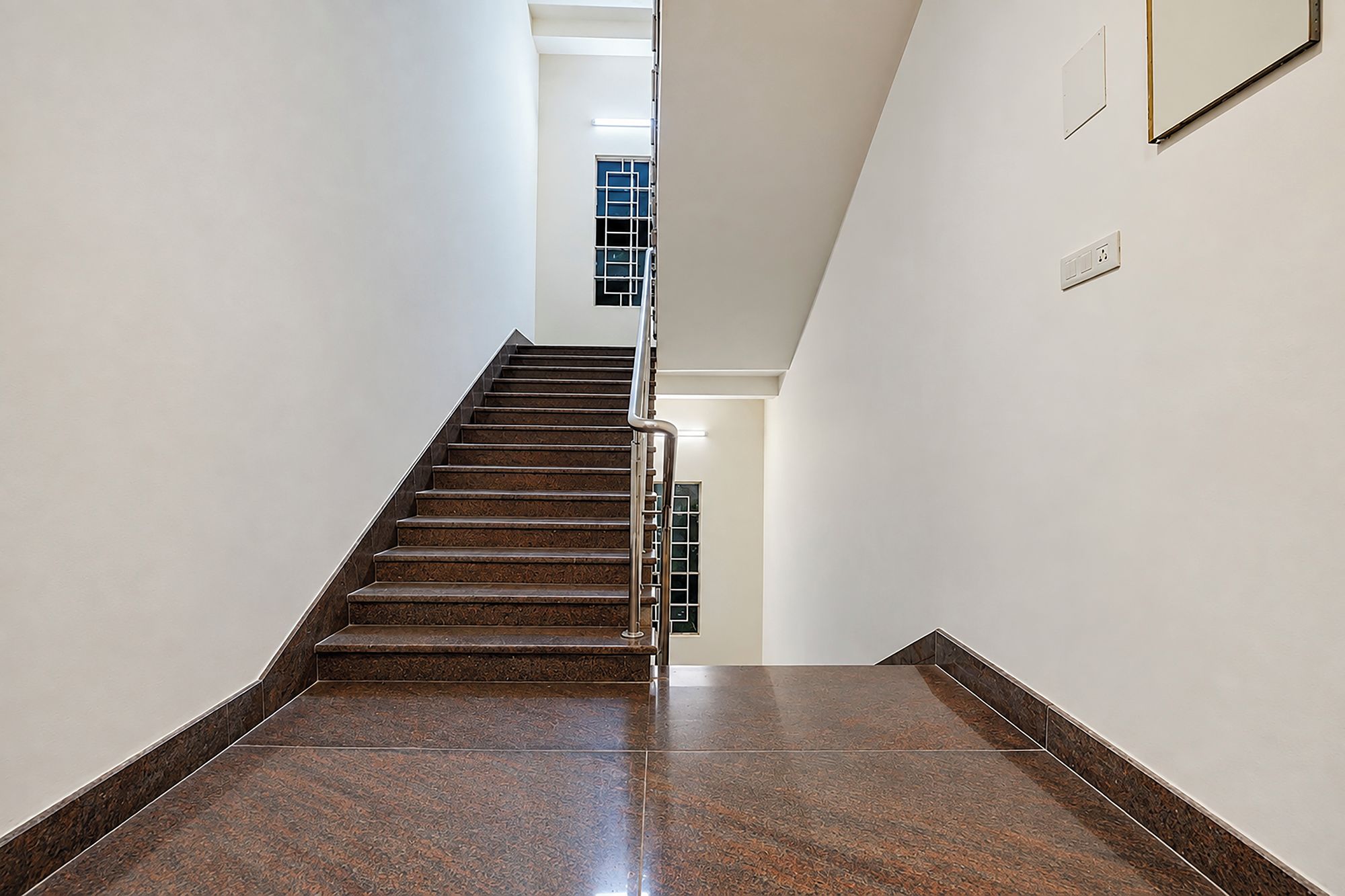 A staircase with a handrail leading to a landing.
