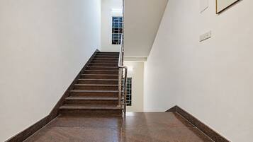 A staircase with a handrail leading to a landing.