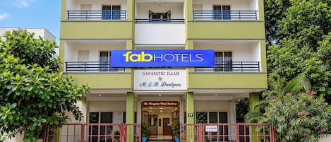 A multi-story hotel with a prominent 'Tab Hotels' sign, a 'Mangrove Wood Residency' label, and a 'No Parking' sign.