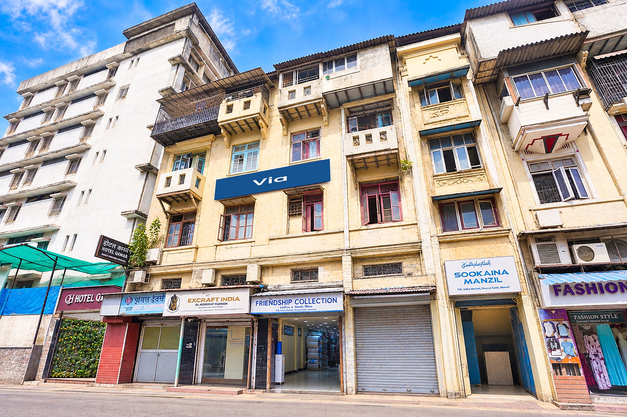 A multi-story building with various commercial establishments, including a hotel, a fashion store, and a furniture store.