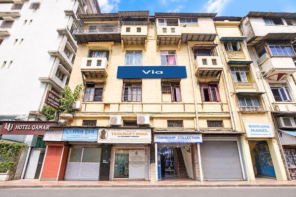 A multi-story building with a prominent 'Via' sign.