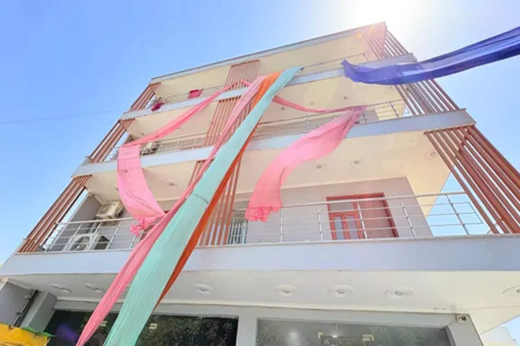 A multi-story building with balconies and a clear sky.