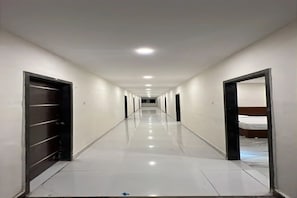 A hotel hallway with doors on both sides leading to rooms. - Fabhotel Akhil Dot Inn (Khammam)