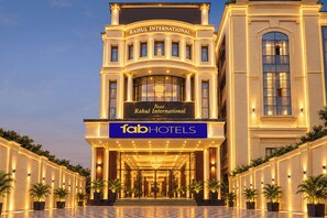 A hotel facade with a prominent sign for 'Rahul International Hotel' and 'FabHotels' branding.