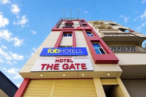 A hotel sign with 'FabHotels' and 'The Gate' branding, indicating a unit of A R Residency.