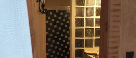 A bathroom with a tiled floor, a sink, and a toilet.
