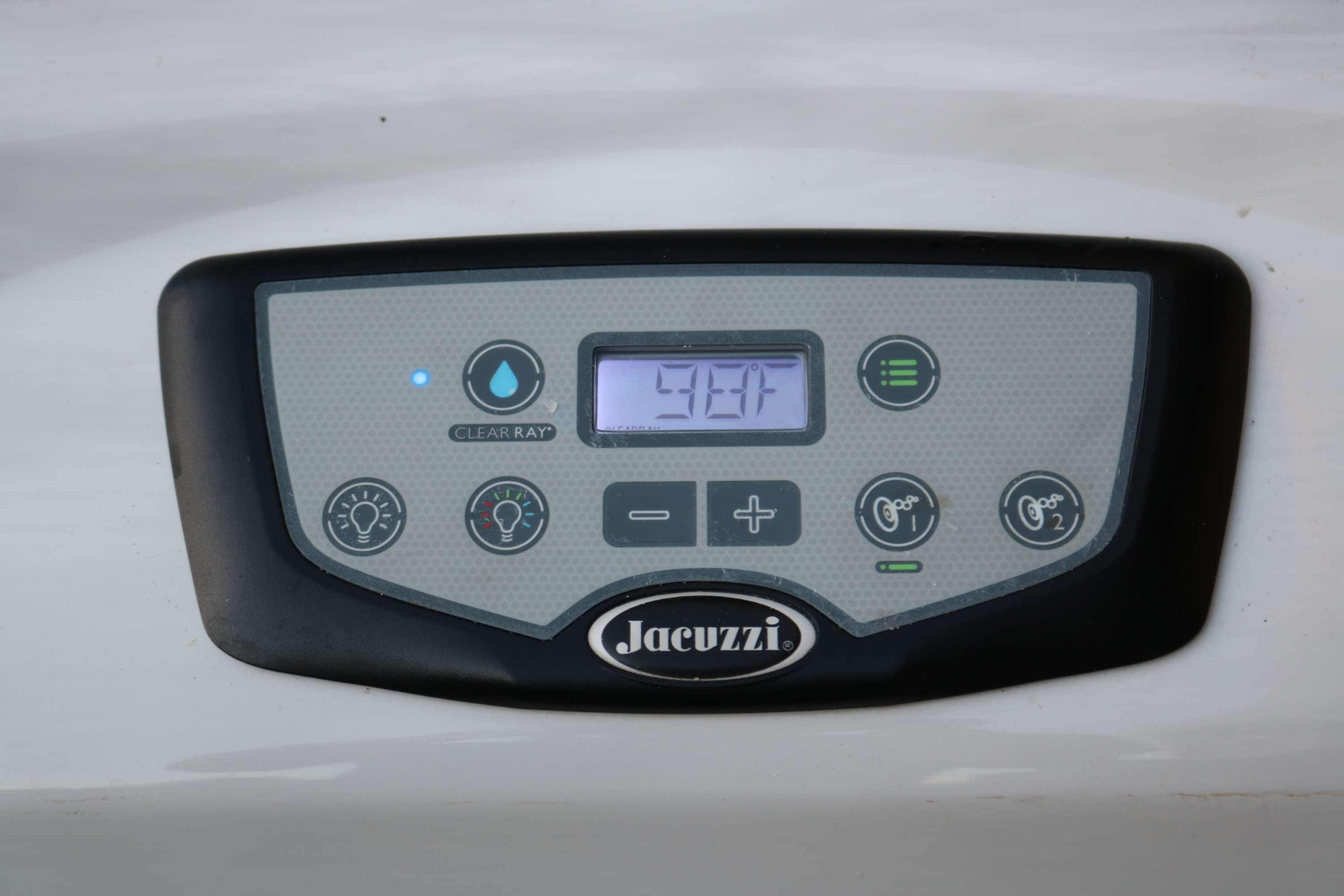 Ein Bedienfeld mit digitaler Anzeige und Tasten, mit dem Markennamen 'Jacuzzi'.