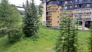 A residential building with multiple balconies and a grassy courtyard. - Vrbo Property (Risoul)