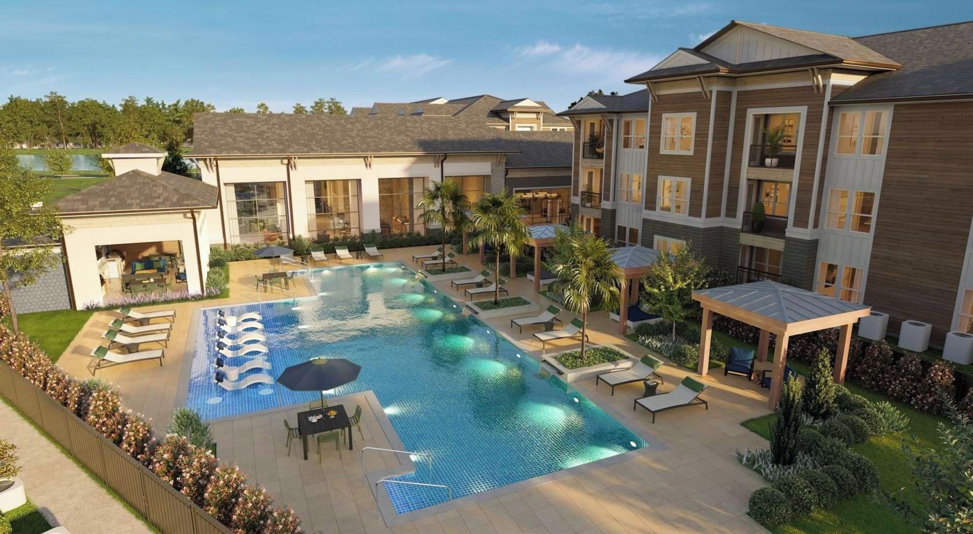 Ein Wohnkomplex mit Schwimmbad, Liegestühlen und einer überdachten Terrasse.