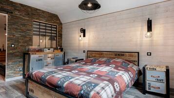 A bedroom with a bed, a dresser, a mirror, and a wall with a wooden panel design.