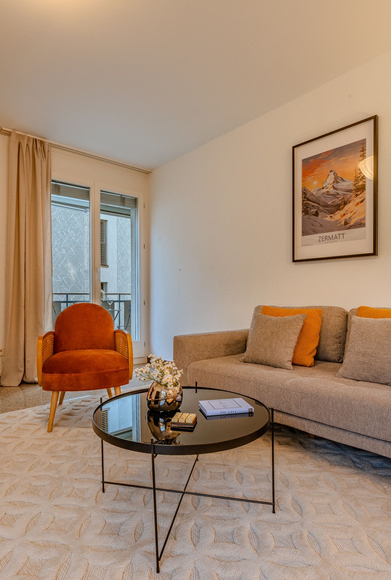 A living room with a sofa, a chair, a coffee table, and a framed picture on the wall.
