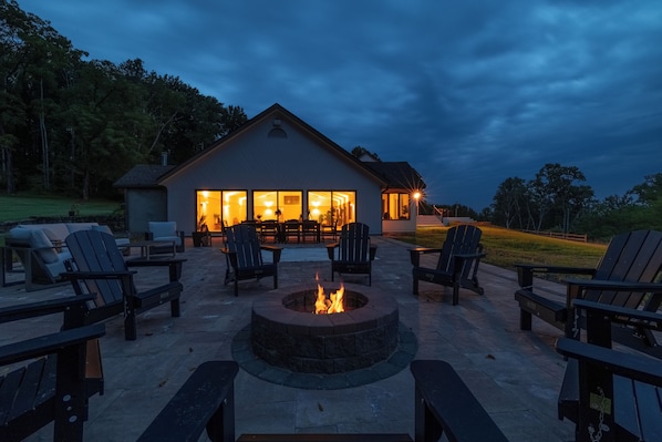 A patio area with outdoor seating and a fire pit.