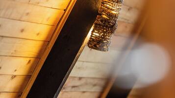 A wooden ceiling with a hanging light fixture.