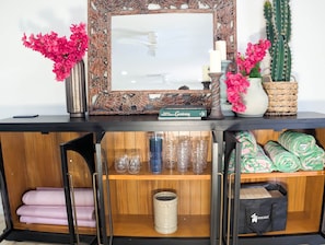 A wooden cabinet with a mirror, decorative items, and a book titled 'Gardening'. - 1 Mi to Old Town | Saltwater Pool + Spa | EV Charger (Scottsdale)