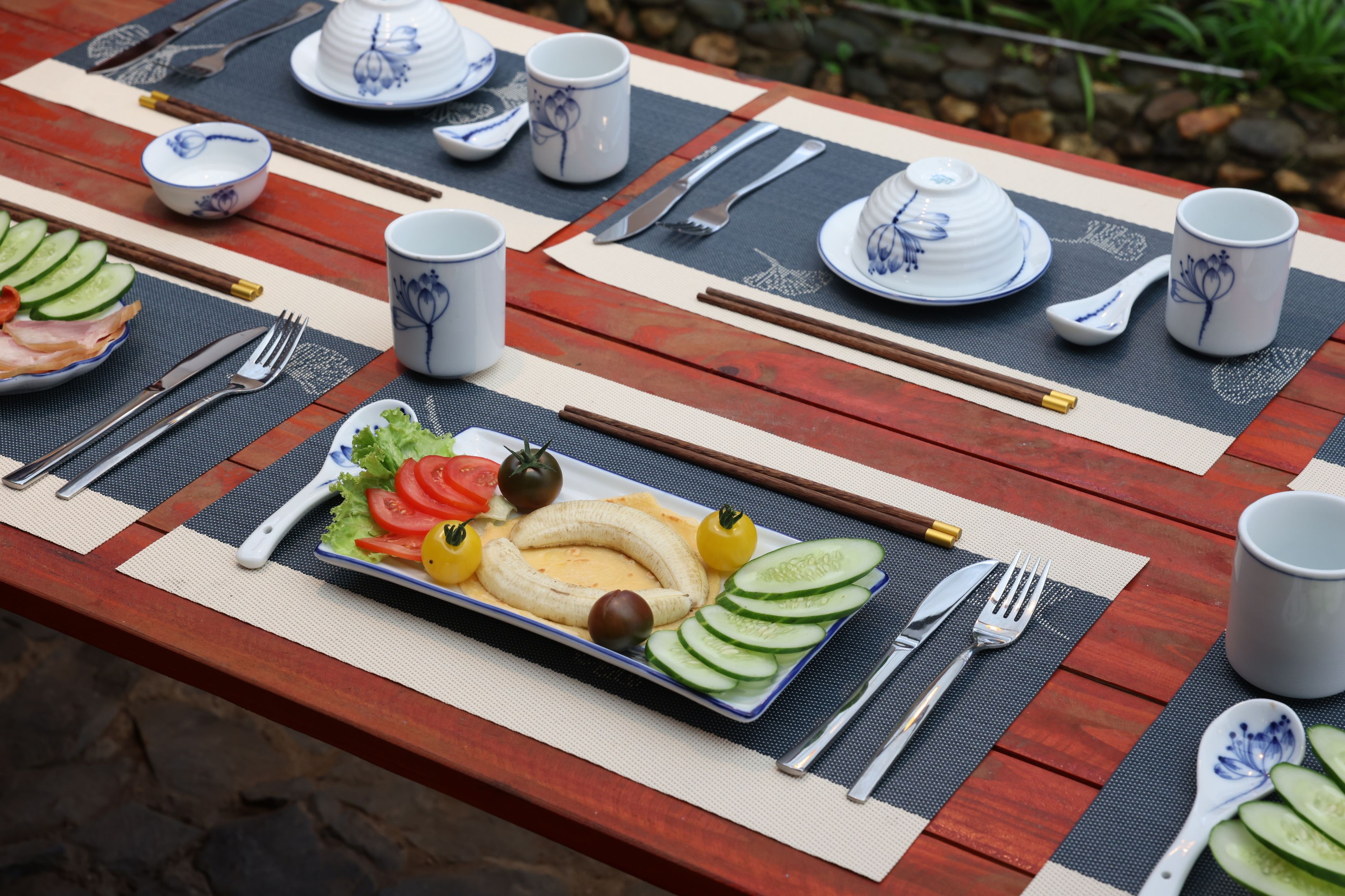 A table set with a meal, utensils, and a placemat.