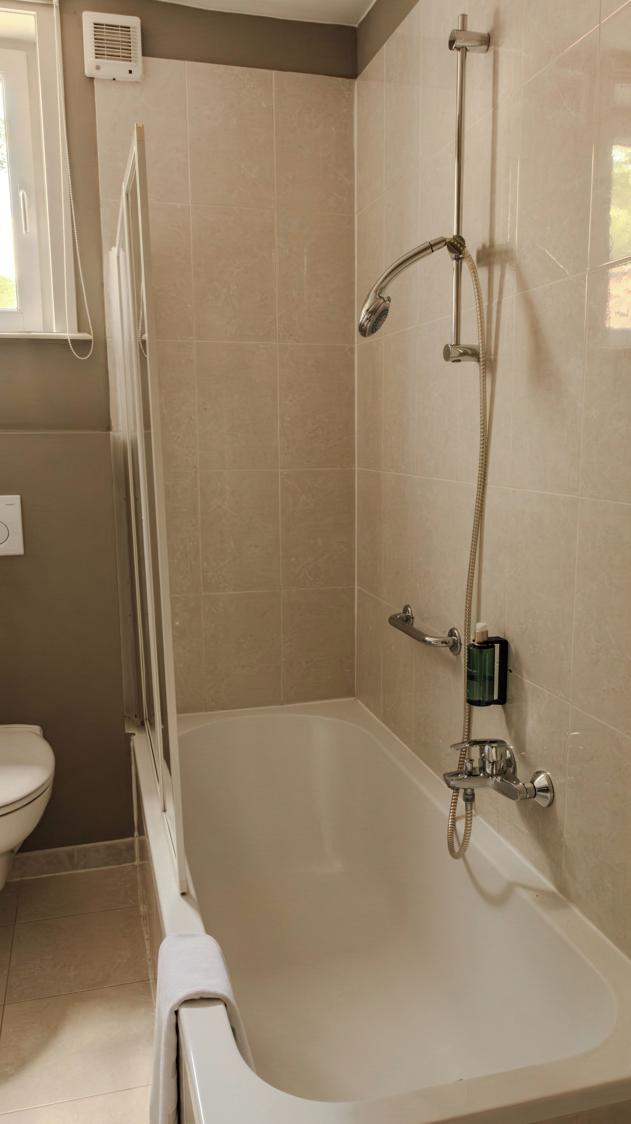 A bathroom with a bathtub, a shower, and a toilet.
