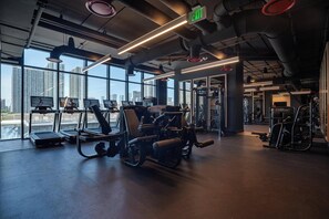 A gym with treadmills, weight machines, and exercise equipment. - Deluxe E11EVEN Studio Suite with Elite Amenities (Miami)