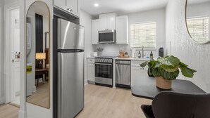 A compact kitchen with a refrigerator, microwave, stove, oven, and dishwasher. - South Tampa Stay | Free Parking (Tampa)