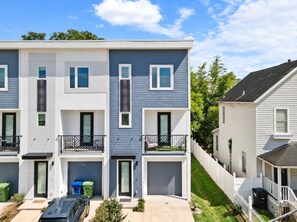A multi-story residential building with balconies, a garage, and a driveway. - Downtown Tampa Retreat | Dining & Riverwalk (Tampa)