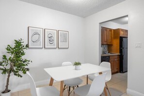 A modern kitchen with wooden cabinets and a black refrigerator. - Bayside Tampa Escape | Pool, Gym & Parking (Tampa)
